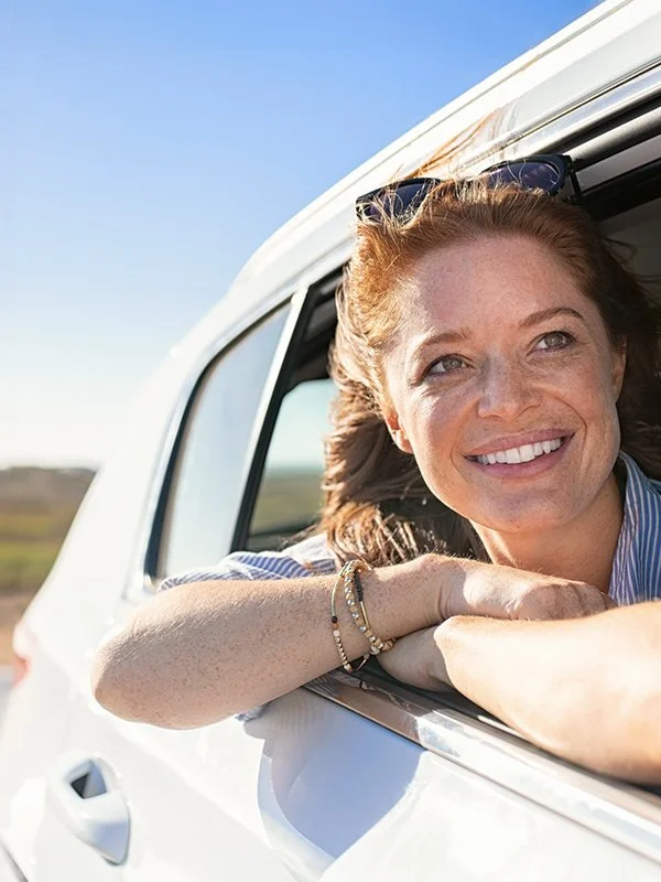 Woman in car covered by vehicle insurance with Redding insurance agent