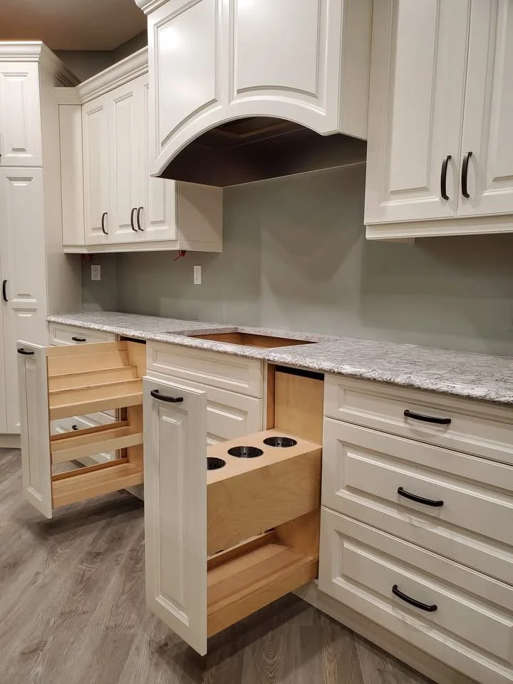 Kitchen cabinets with some drawers open, revealing construction in progress.