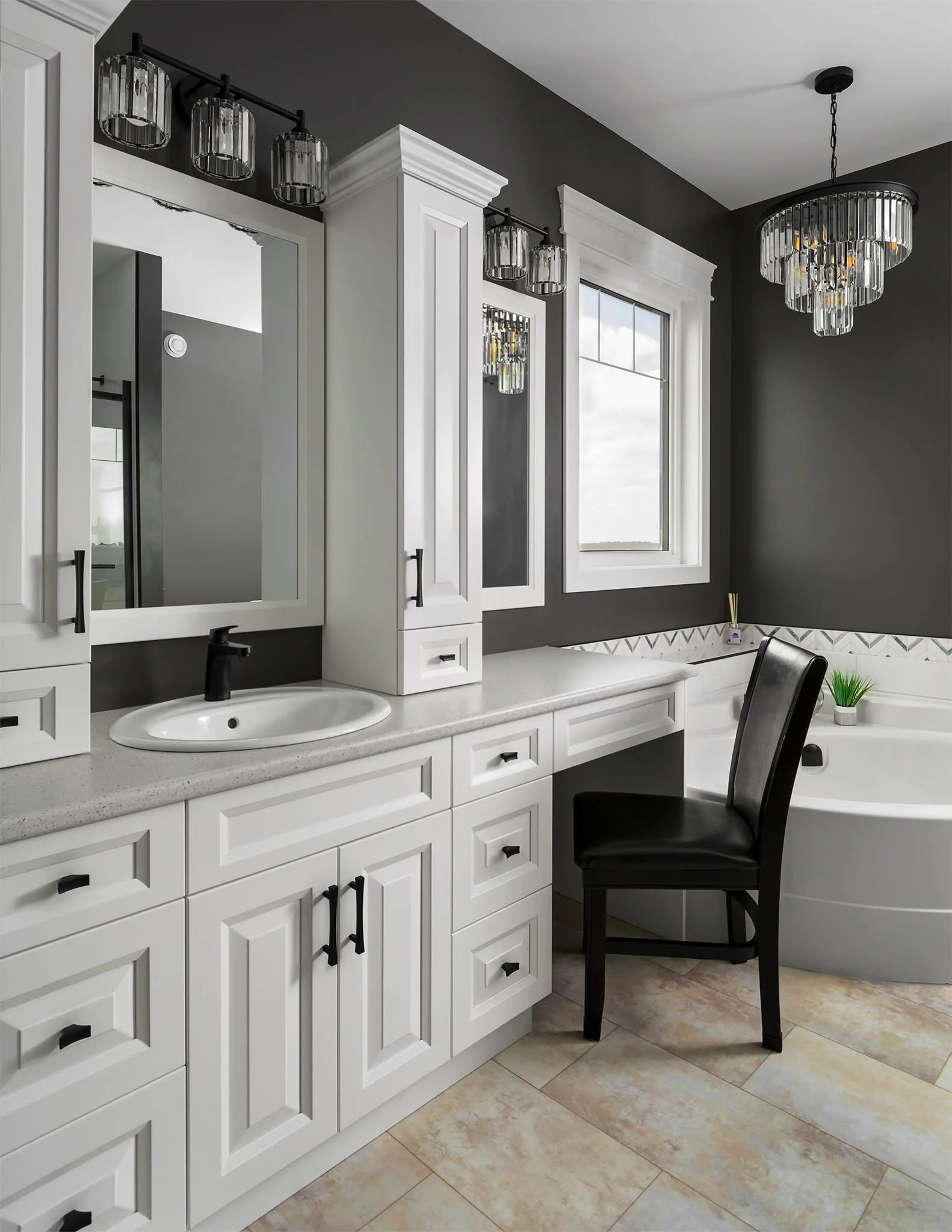 Modern bathroom with white cabinetry, black fixtures, a white vessel sink, a large window, and a corner bathtub with green plants.