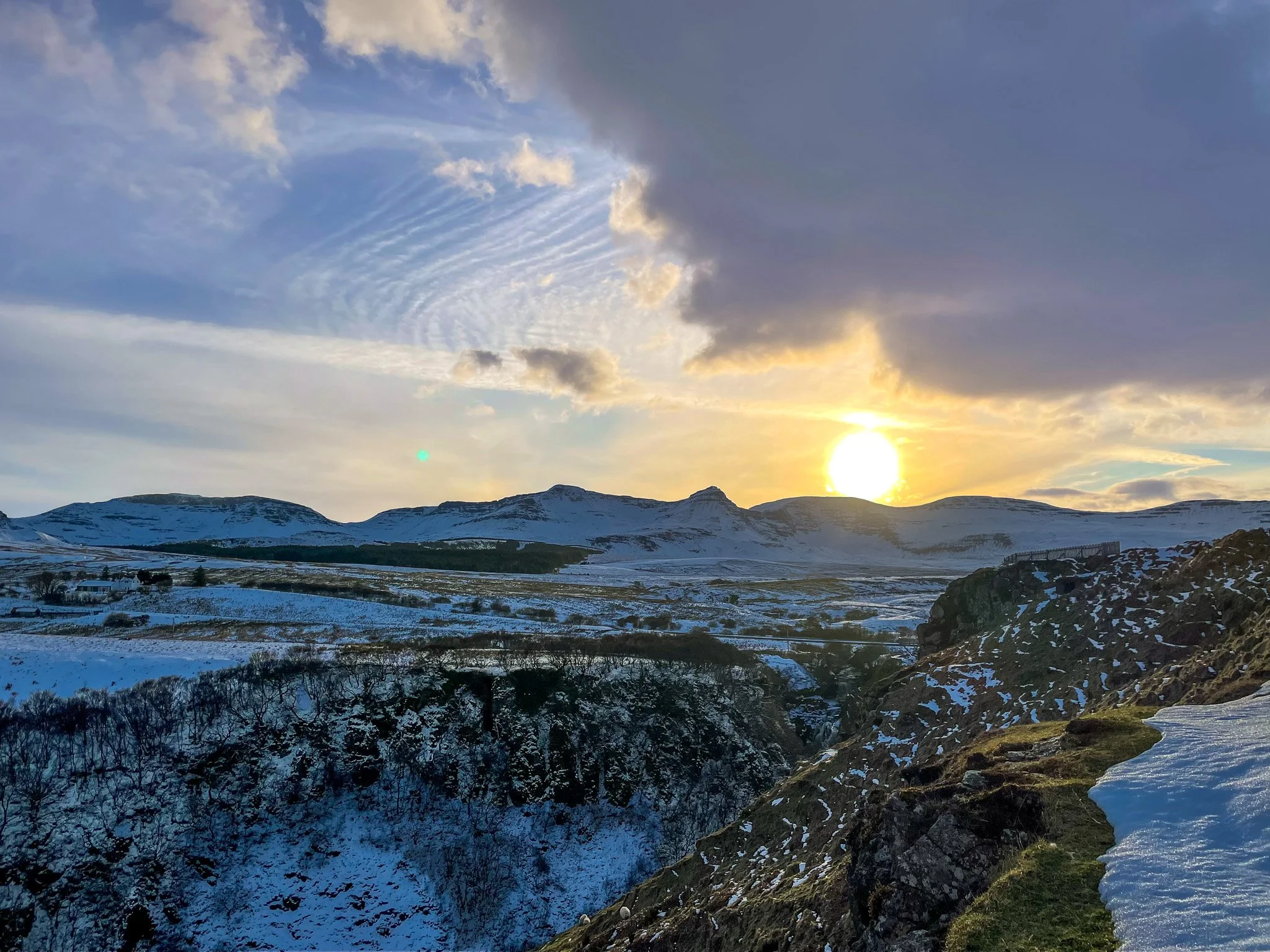 A winter sunset over snow covered hills on the Isle of Skye