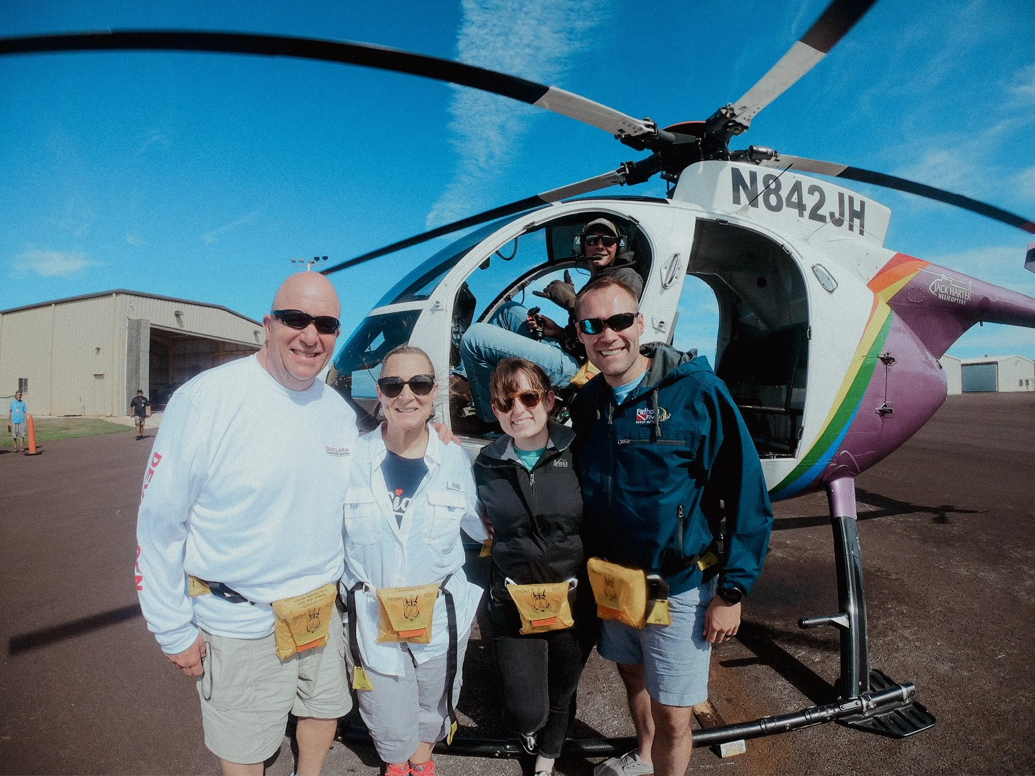 author and family standing beside a helicopter in Kauai