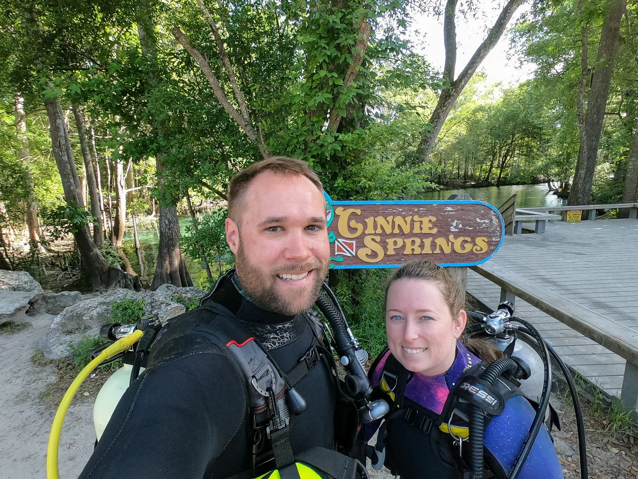 author and husband with Ginnie Springs sign