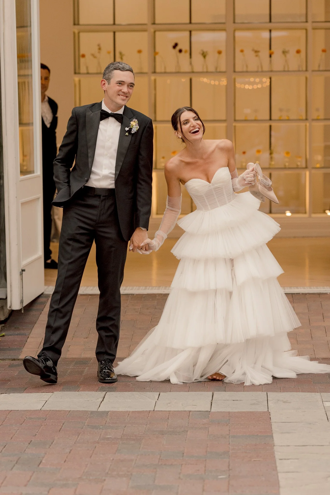 Bride and groom making a grand entrance at their Chicago Illuminating Company wedding reception