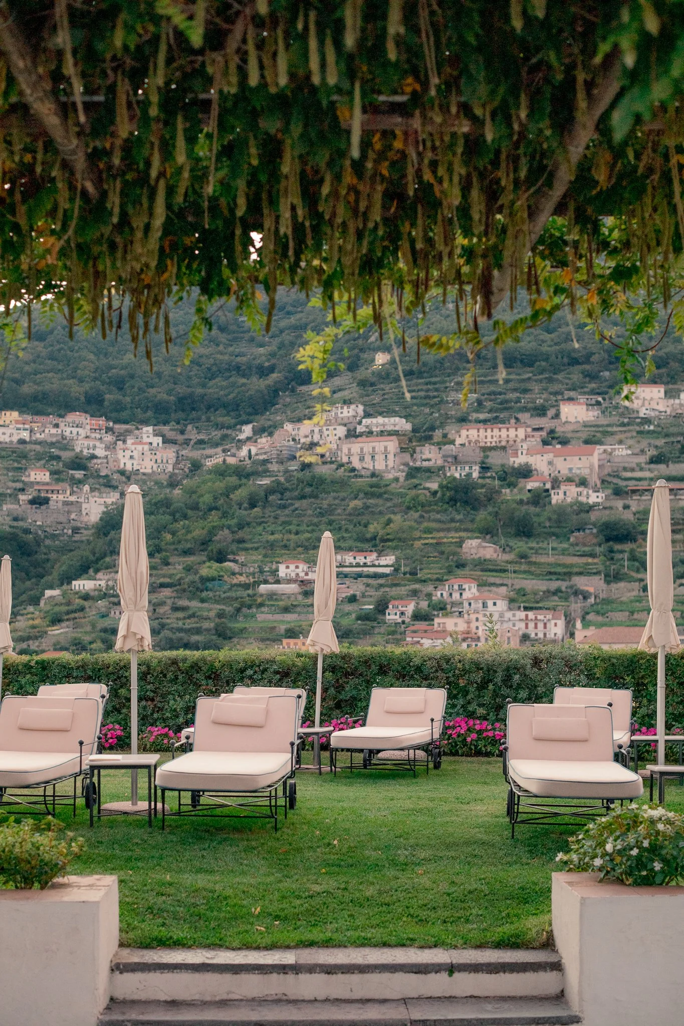 Scenic landscape at Belmond Hotel Caruso featuring lawn chairs on the grounds