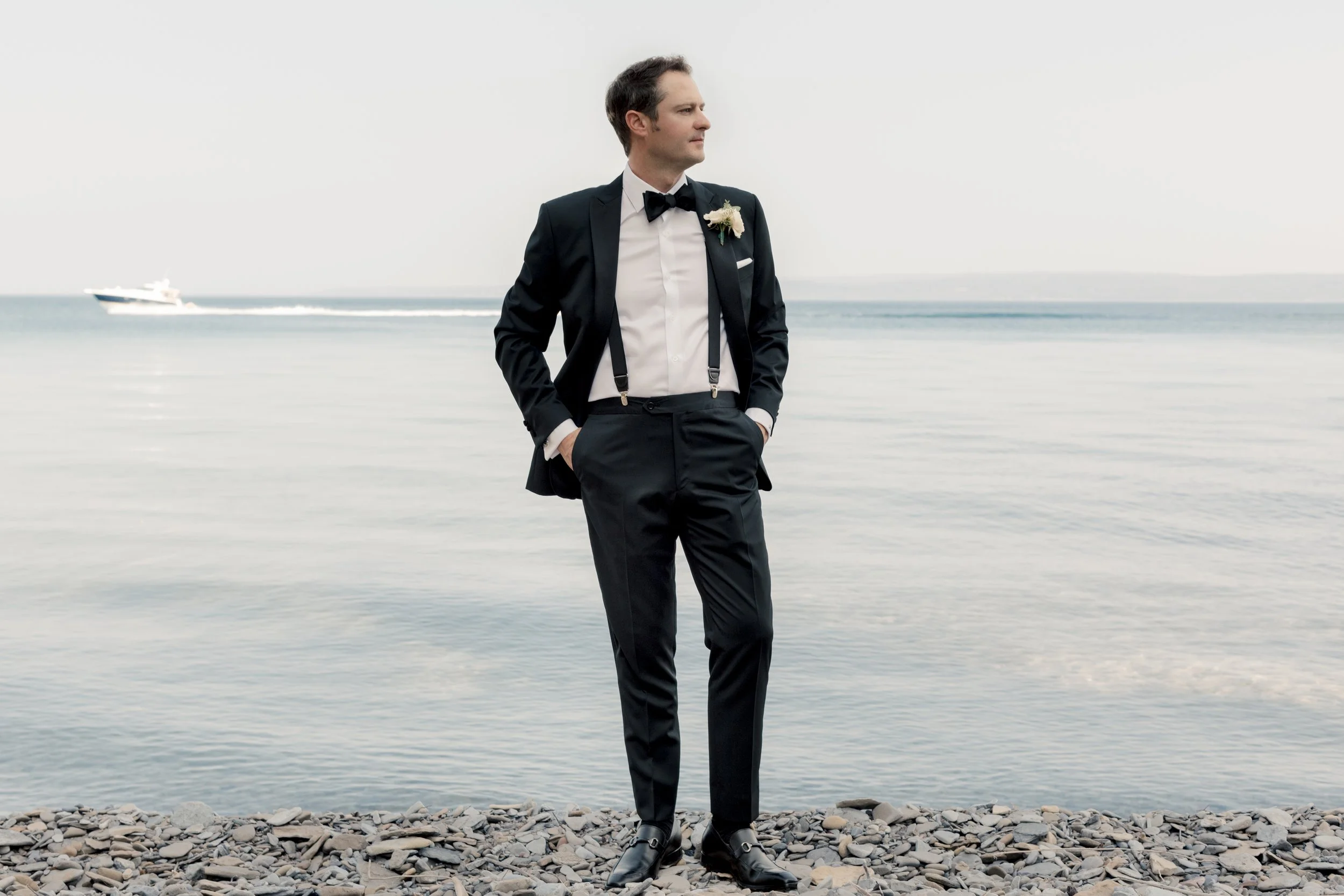 Modern portrait of a groom on the shores of Lake Michigan