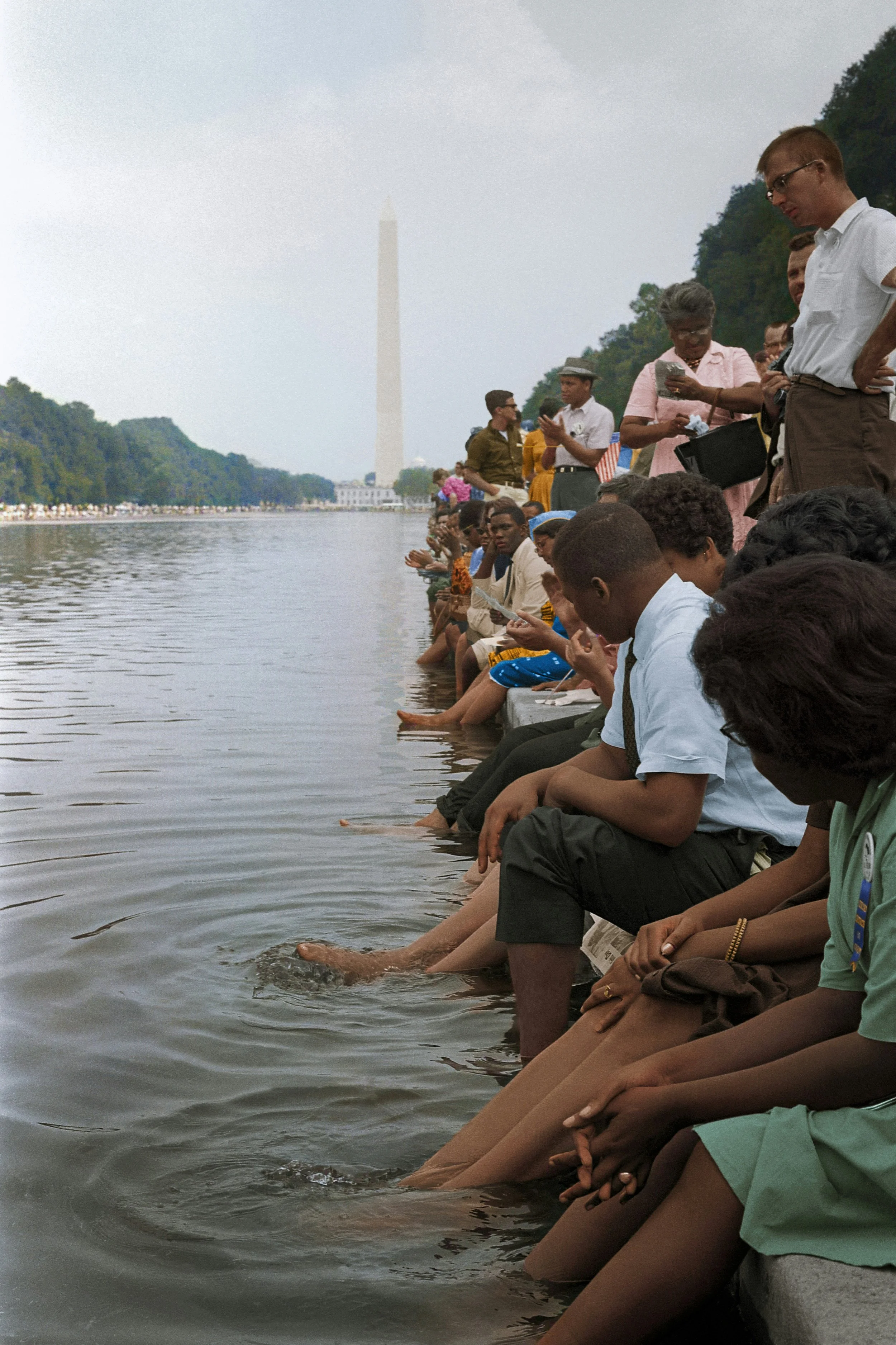 Citizens sitting with their feet in water waiting during the 1963 March on Washington