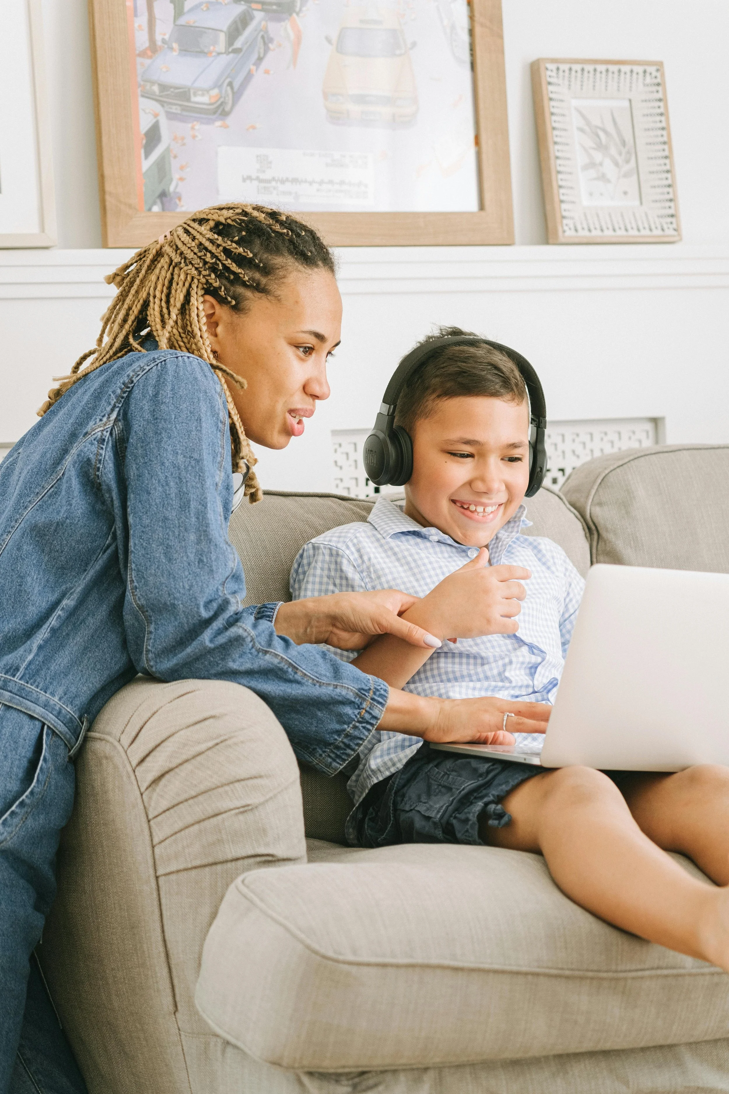 A parent and child working on a laptop together