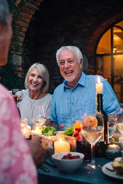 mature-adults-dining-outdoors-by-candlelight.webp
