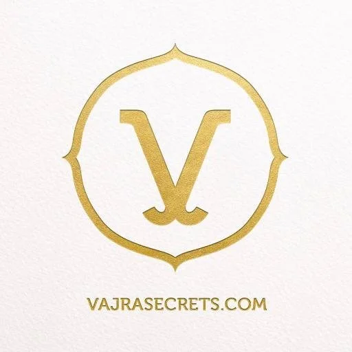 Gold logo with a stylized letter V inside a decorative border, and the text 'VAJRASECRETS.COM' below.