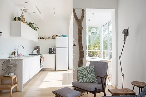 Bright kitchen with a brick and wood partition