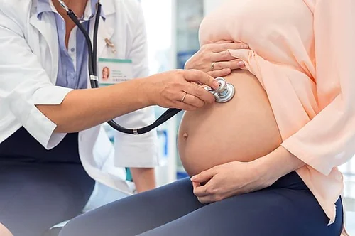 Pregnancy checkup with a stethoscope