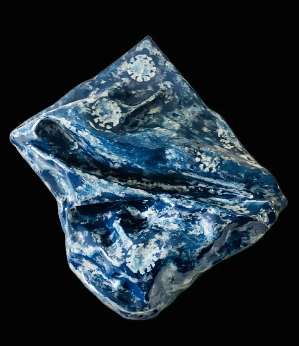 A crystal resembling the Earth with patterns of land and ocean in blue and white, set against a black background.