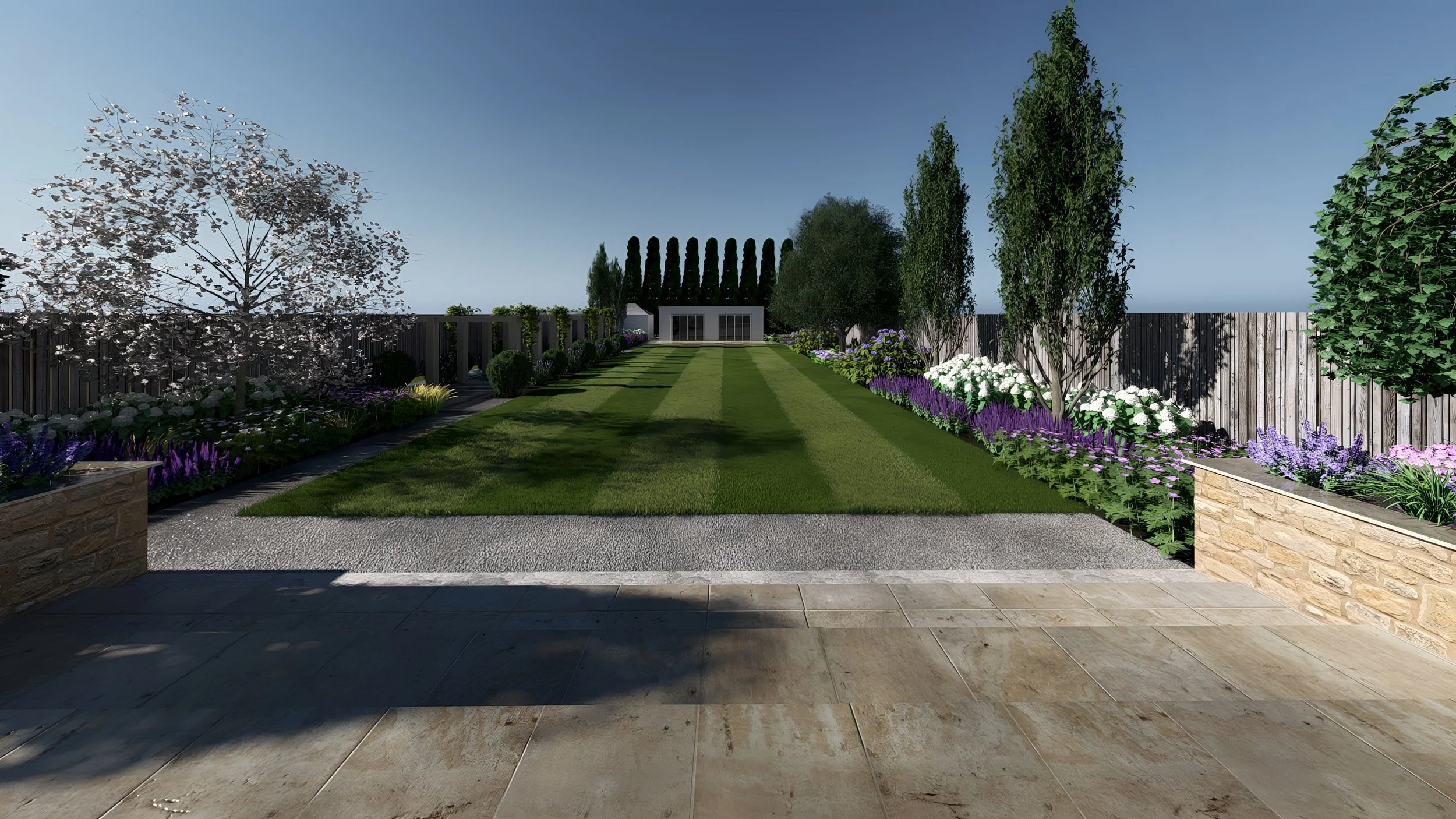 A landscaped backyard with a stone patio, trimmed grass, flowering bushes, and trees, enclosed by a wooden fence.