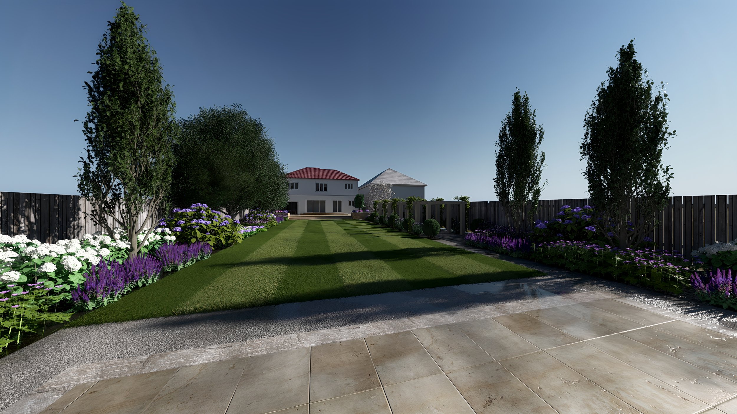 A backyard garden with manicured grass, flower beds with purple and white flowers, and tall trees, with a house in the background under a clear blue sky.