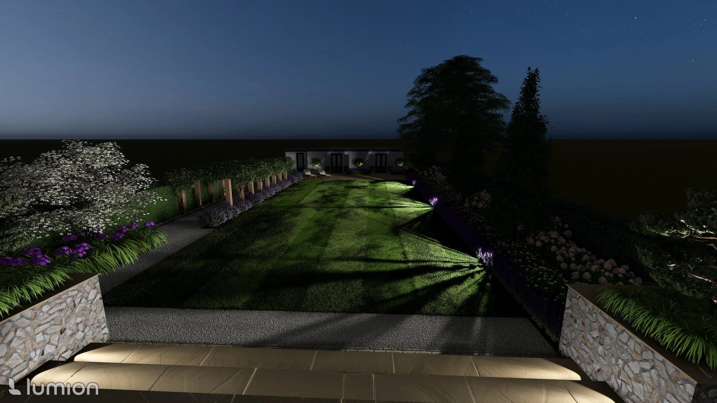 Night view of a landscaped backyard garden with a stone patio, illuminated plants, a grassy lawn, and outdoor seating in the background.