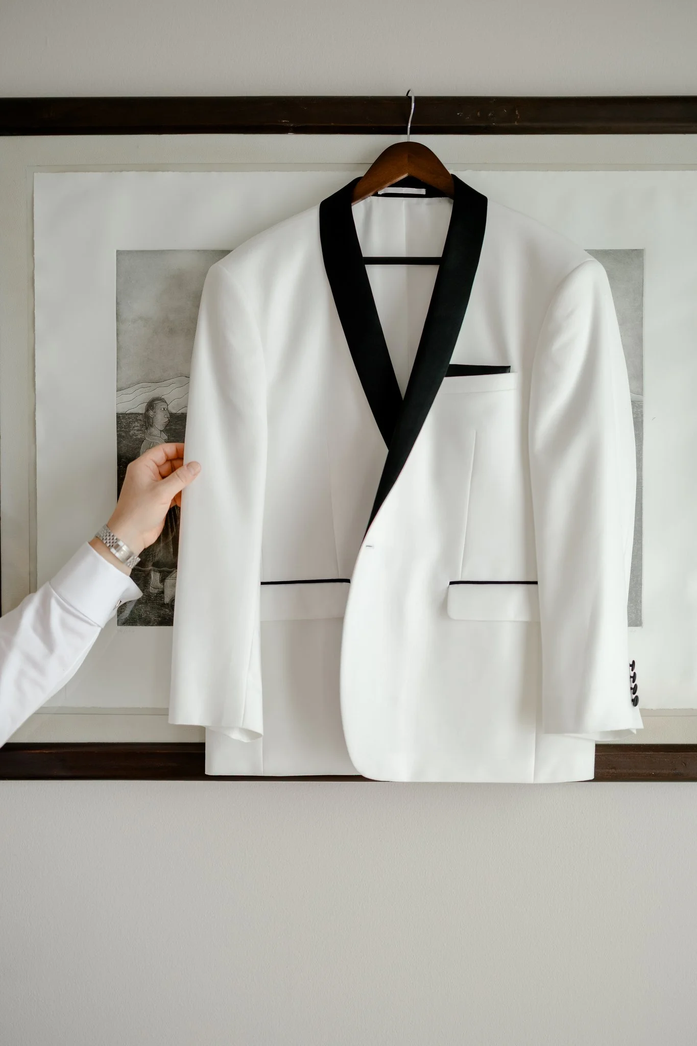 Groom grabbing White Suit Detail shot.