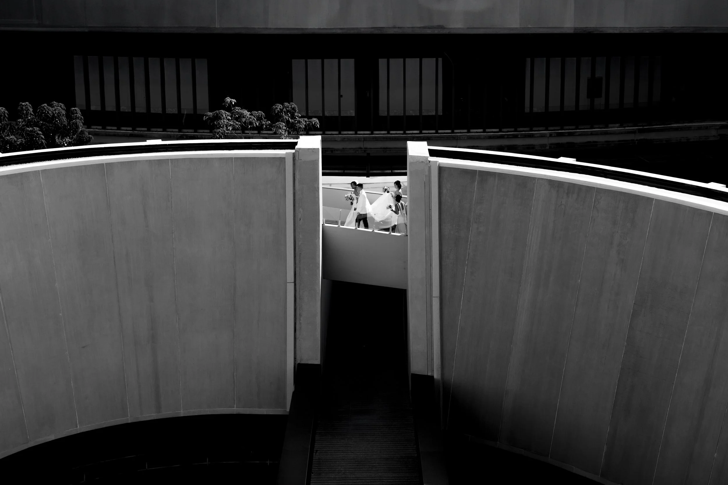 Wedding party walks across an architectural feature at a resort in Puerto Vallarta Mexico