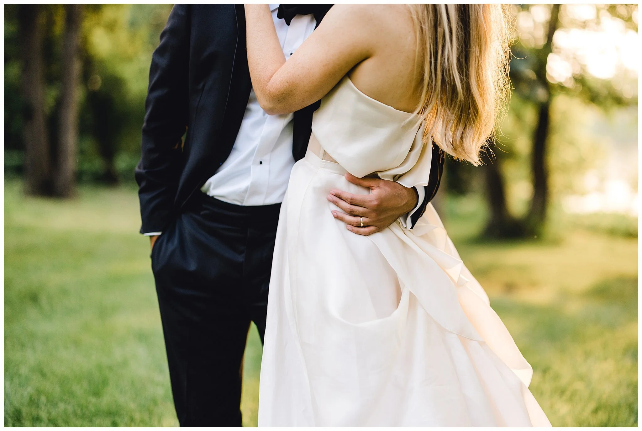 Groom effortlessly pulls bride in close for a kiss.