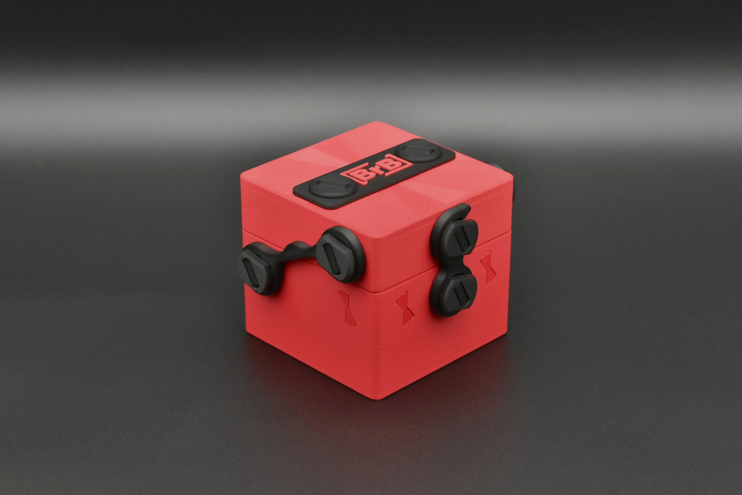 A securely closed Token Box in a striking Red and Black color scheme, showcasing its durable build and compact design.