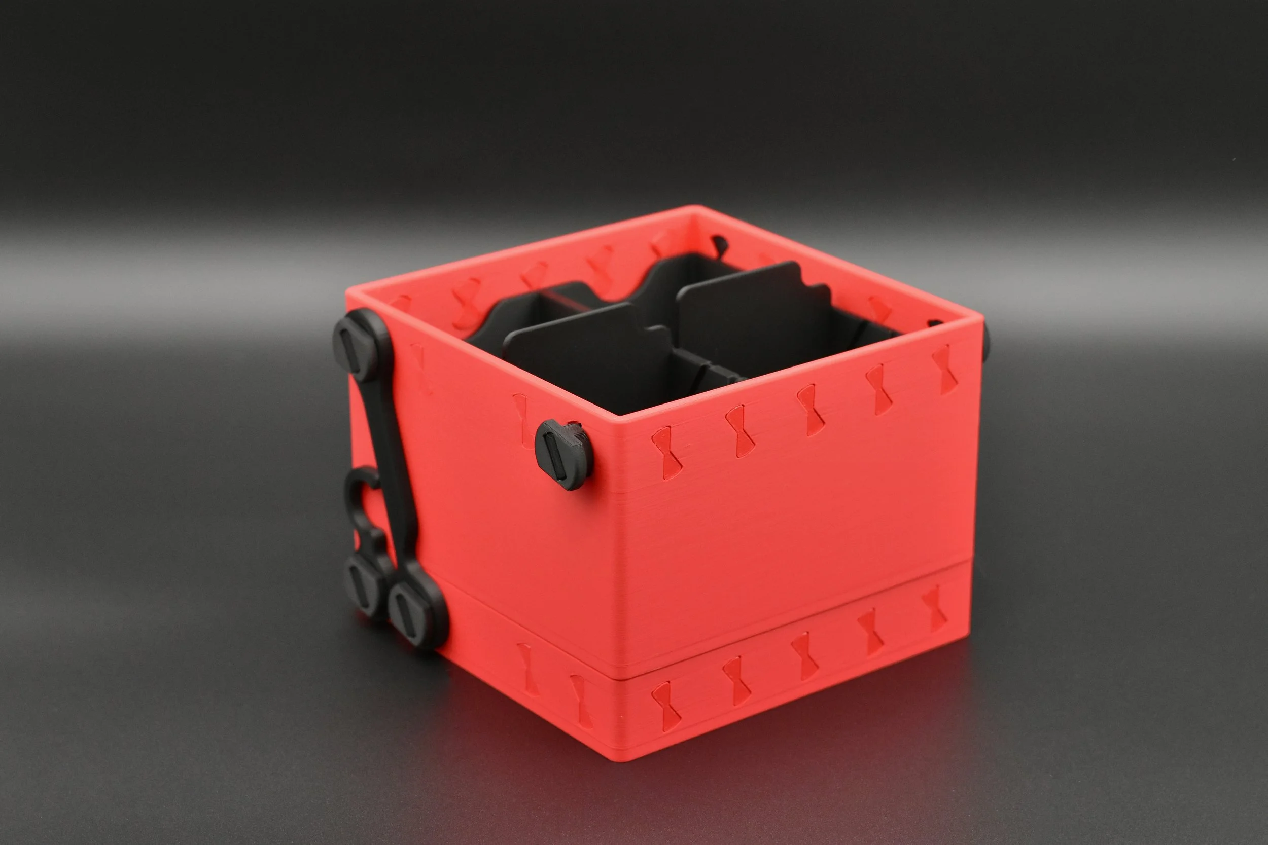 The Red and Black Commander 4-Pack with its lid folded under the base to showcase its unique, space-saving design for game night.