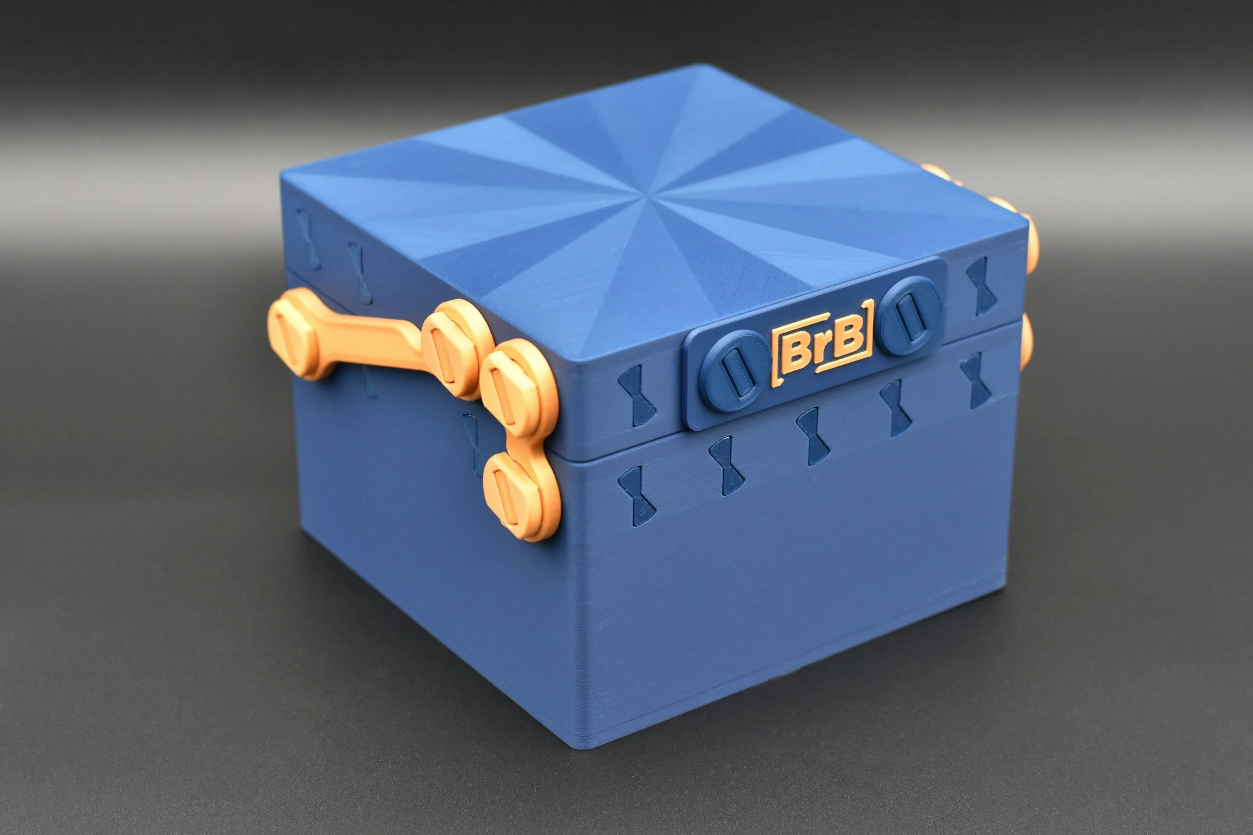 A securely closed Commander 4-Pack deck box in a Blue and Gold color scheme, showing the front latch and detailed lid design.
