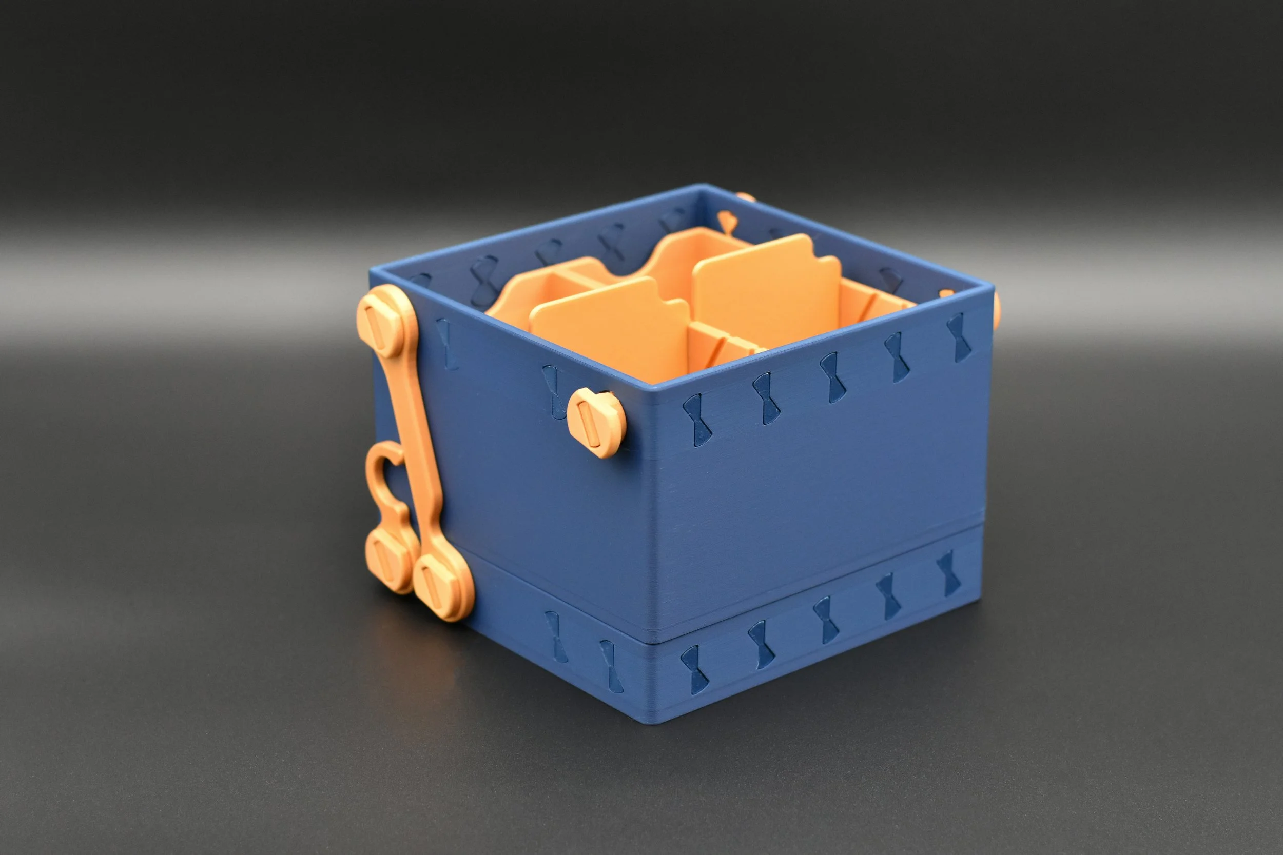 The Blue and Gold Commander 4-Pack demonstrating its space-saving fold-under lid feature, designed for a minimal footprint on the gaming table.