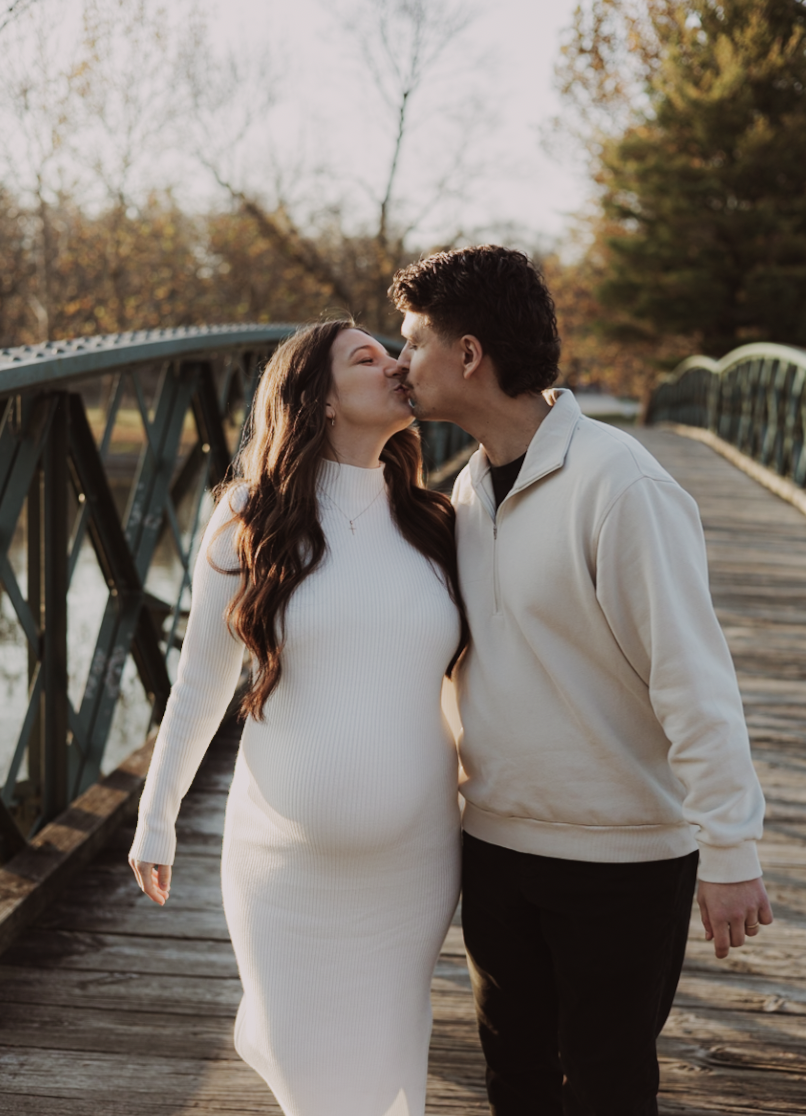 Kissing on a bridge engagement photo