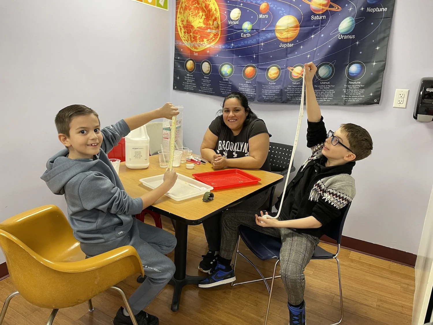 Teacher working with students during occupational therapy.