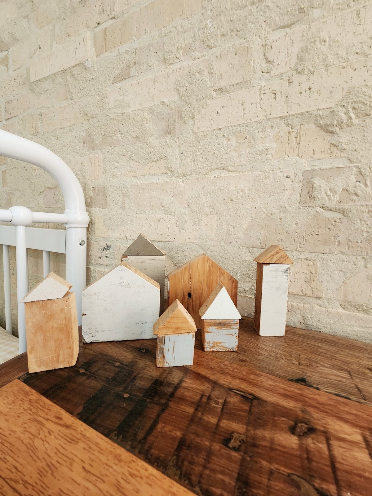 Little wooden houses on a furniture top.