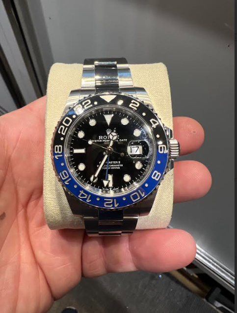 A pre-owned Rolex GMT-Master II Batman watch with the iconic blue and black ceramic bezel evaluated at Scranton Gold Buyers.
