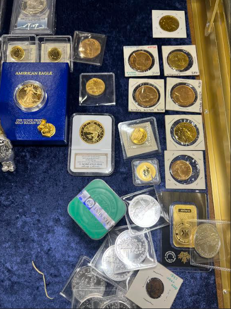A diverse collection of gold and silver coins being appraised for cash value at Scranton Gold Buyers.