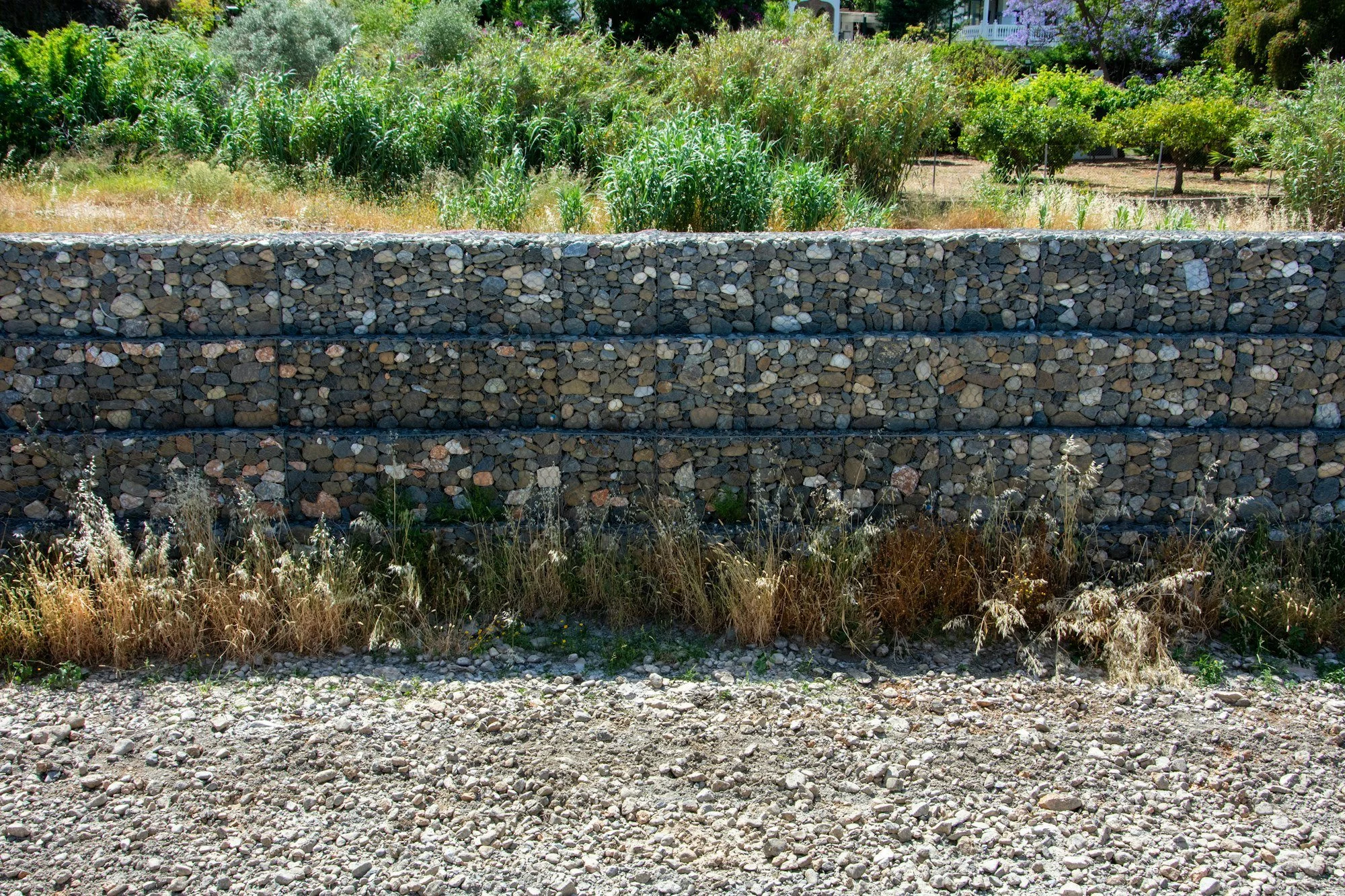 Retaining wall with gravel drainage behind it on a sloping site