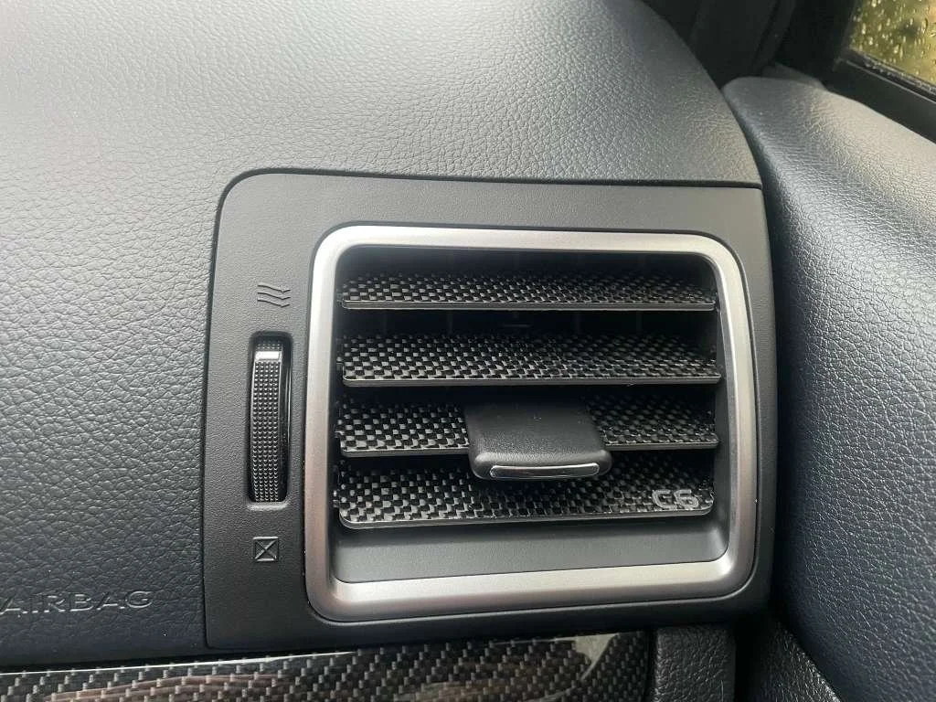 Car air vent on the dashboard of a vehicle.