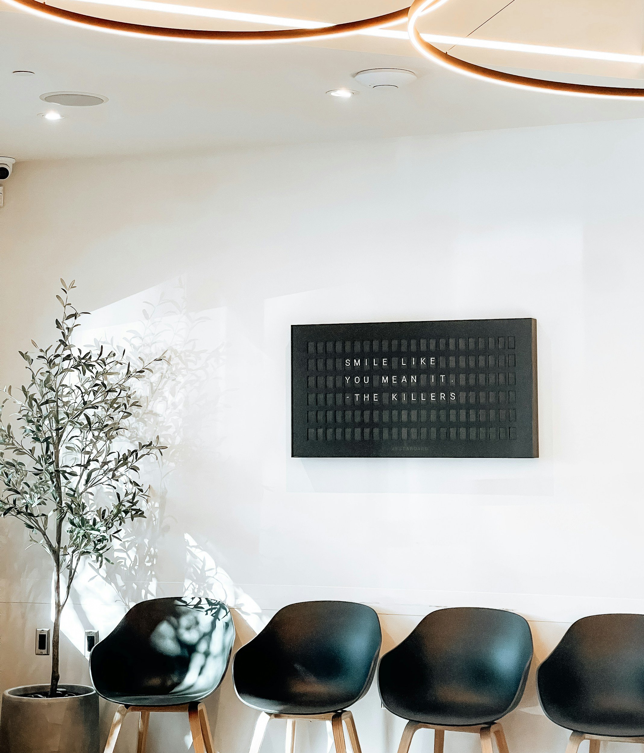 Clean dental office waiting room with reception seating