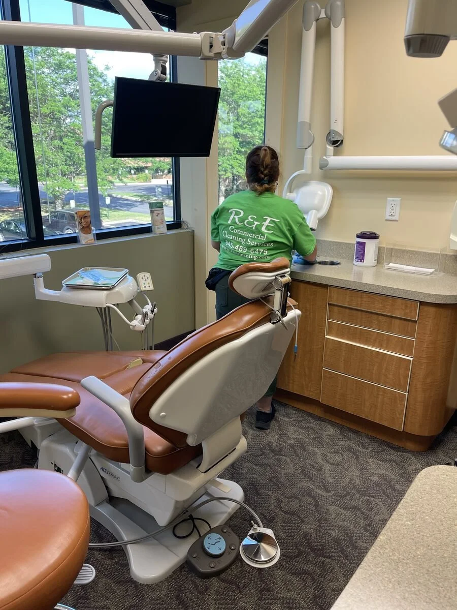 Clean dental clinic treatment room with dental chair and equipment