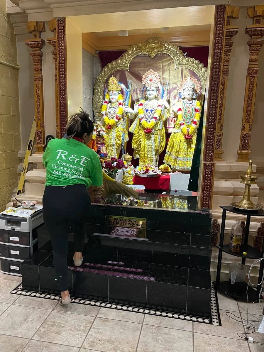 cleaning staff carefully dusting temple altar during religious facility cleaning service in New York