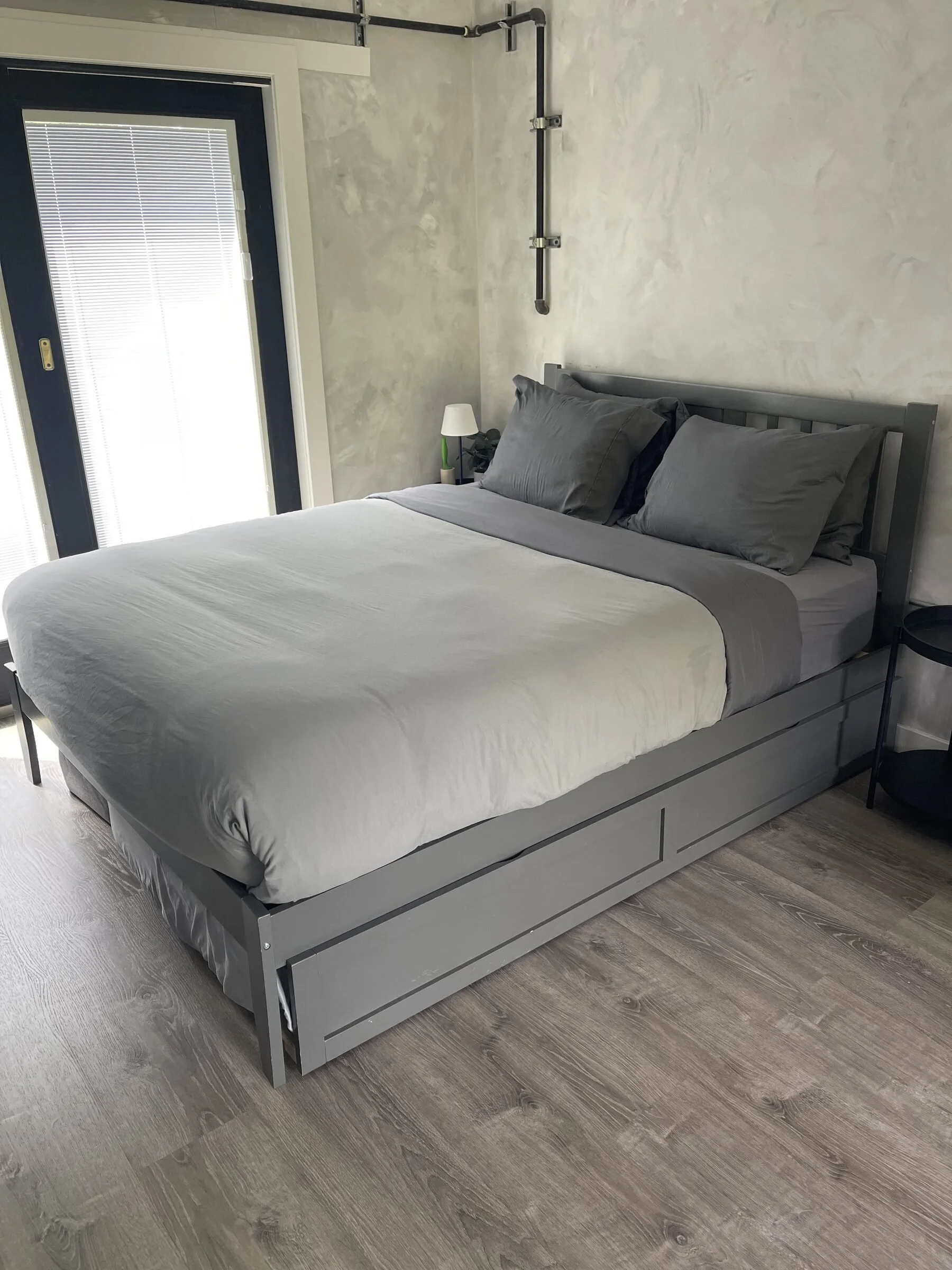 Clean airbnb bedroom with bunk beds, hardwood floors, and neatly made bedding after professional house cleaning.