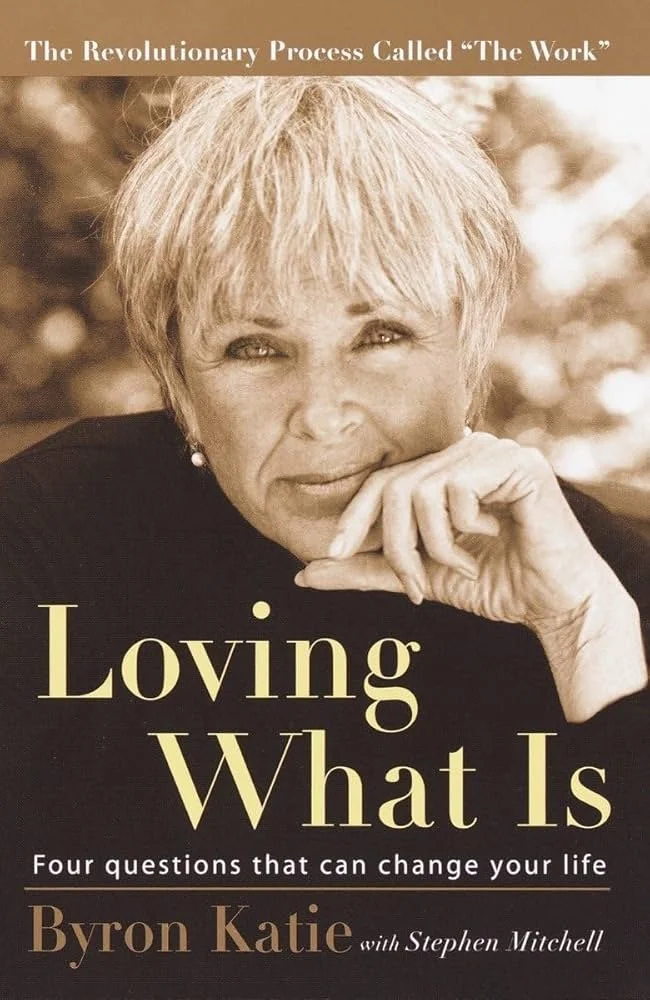 Book cover featuring a close-up sepia-toned photograph of a woman with short blonde hair, resting her chin on her hand. The title is "Loving What Is" with a subtitle, "Four questions that can change your life." The author's name is Byron Katie, with Stephen Mitchell as a co-author. The top of the cover states, "The Revolutionary Process Called 'The Work.'"