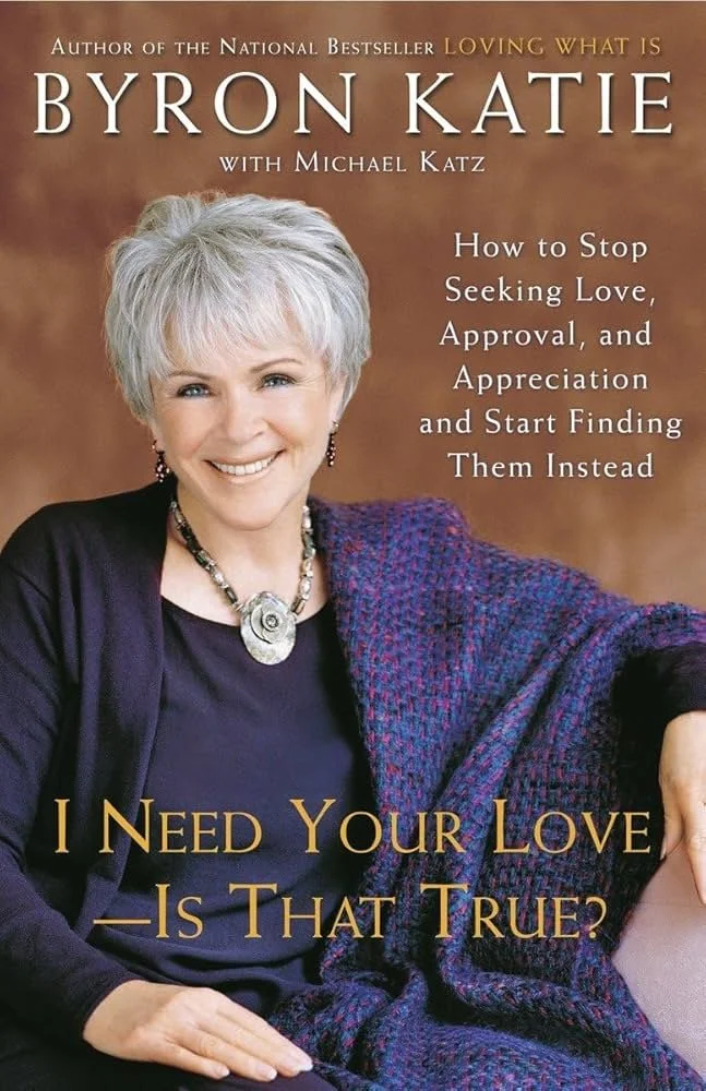 Book cover featuring a woman with short white hair, wearing a dark top and colorful shawl, smiling, with the title 'I Need Your Love - Is That True?' by Byron Katie.