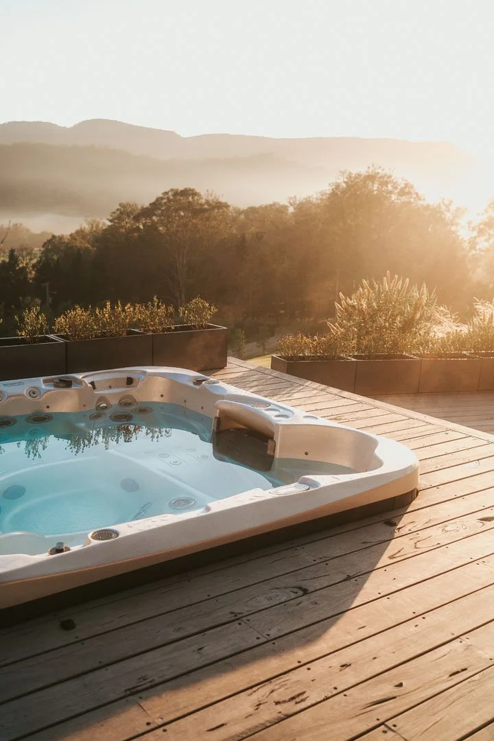 Private hot tub on deck at Rea Rea Lodge with panoramic escarpment and mountain views in Kangaroo Valley