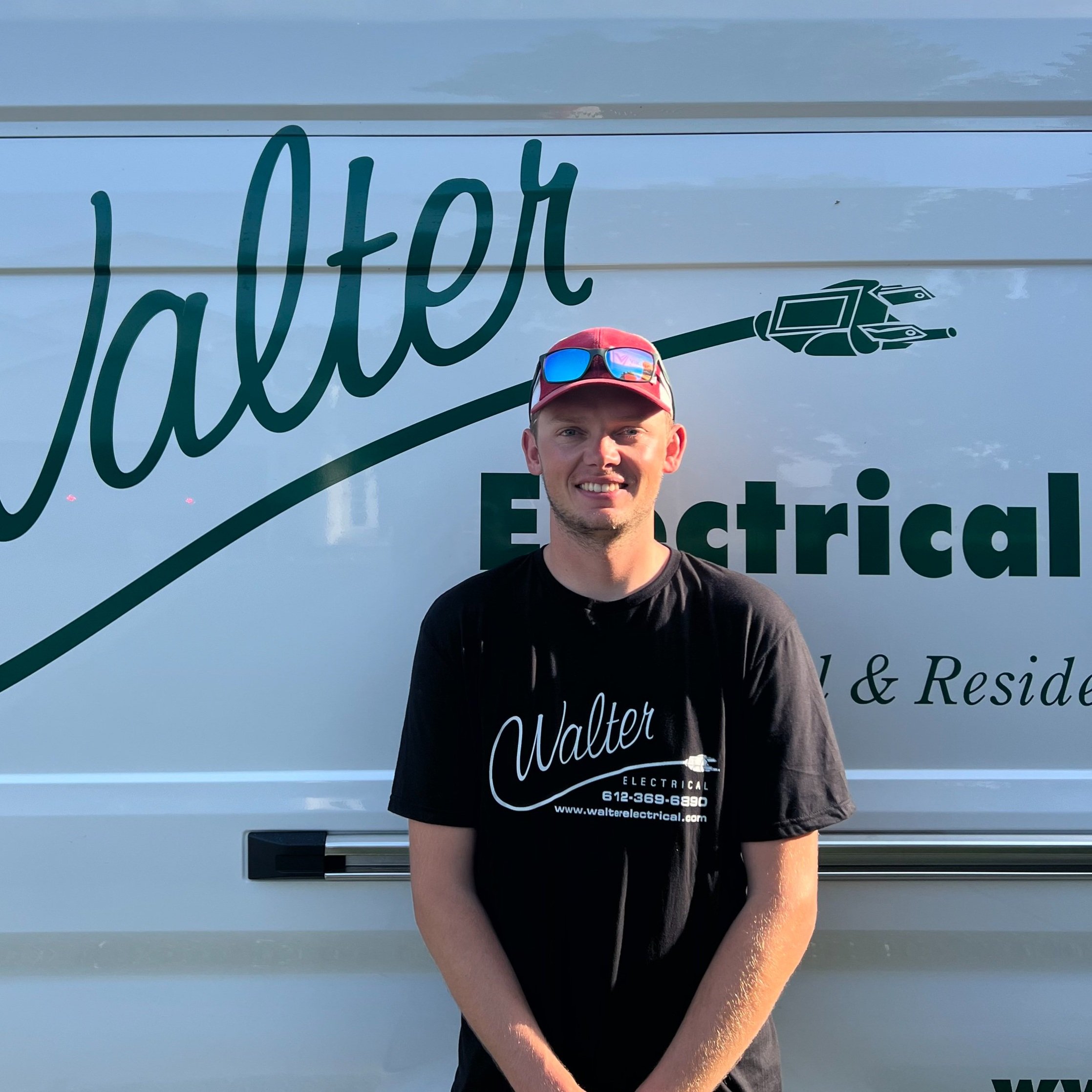 Walter Electrical Contractors licensed electrician standing in front of branded company van, serving Twin Cities residential and commercial clients.