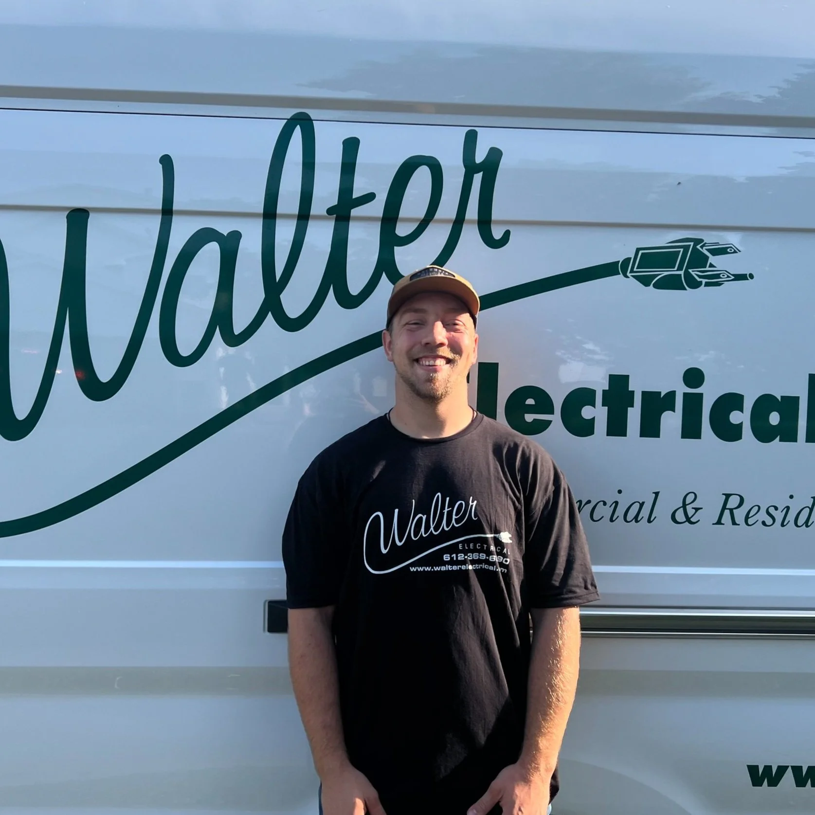 Walter Electrical Contractors licensed electrician standing in front of branded company van, serving Twin Cities residential and commercial clients.