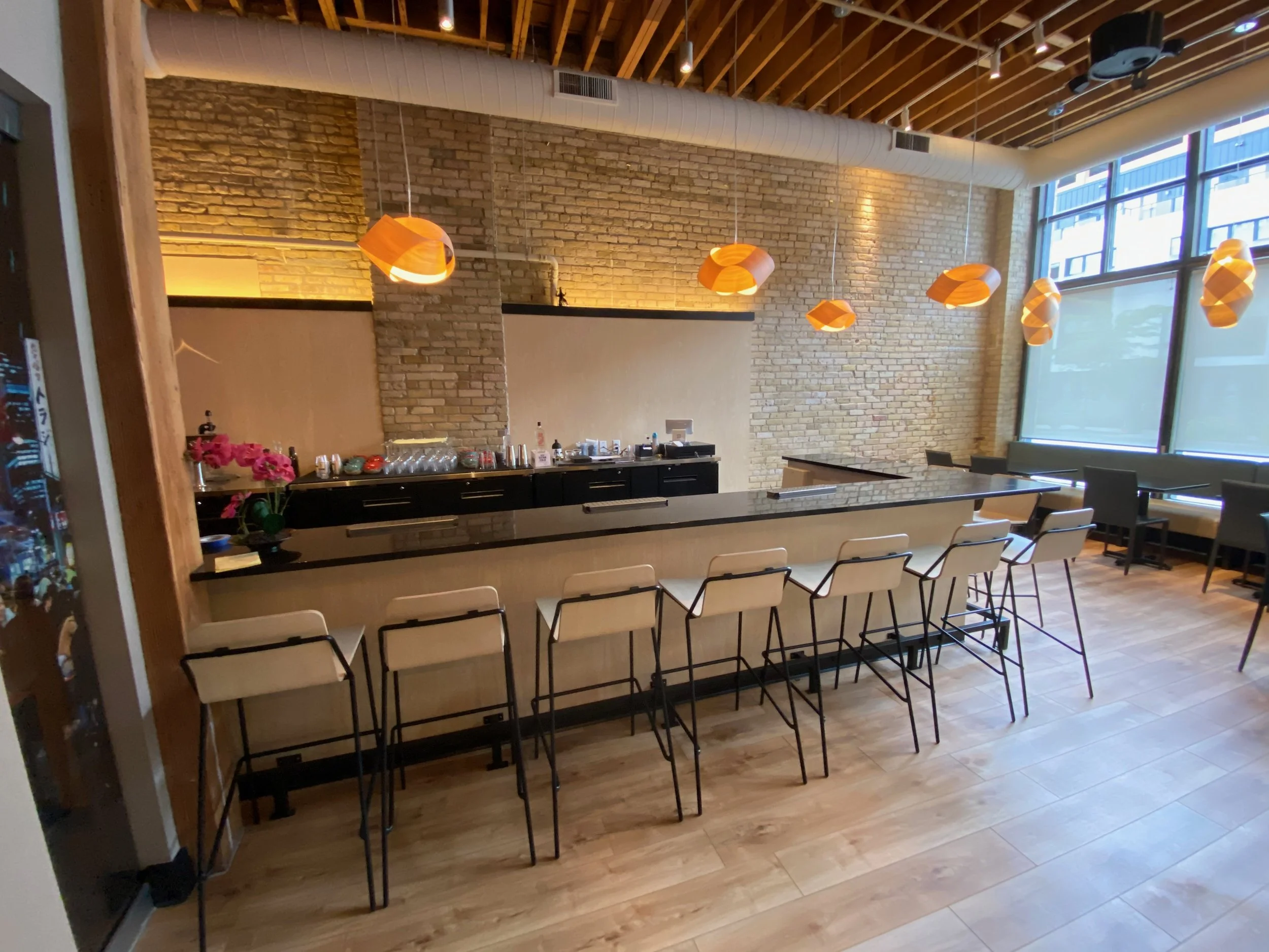 Commercial modern cafe electrical work by Walter Electrical Contractors in Minnesota, including bar counter outlets, pendant lighting, and general illumination for customer seating.