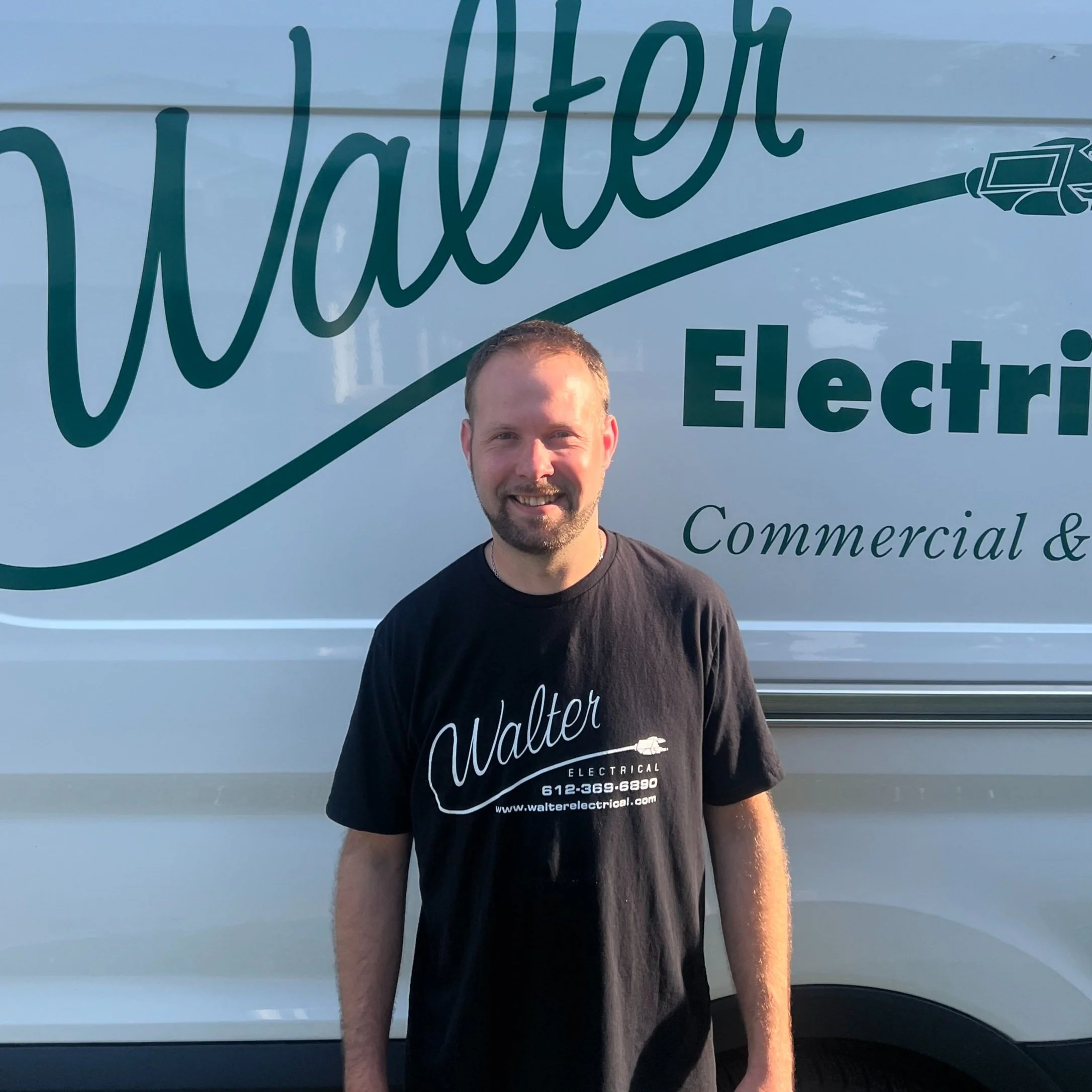 Walter Electrical Contractors licensed electrician standing in front of branded company van, serving Twin Cities residential and commercial clients.
