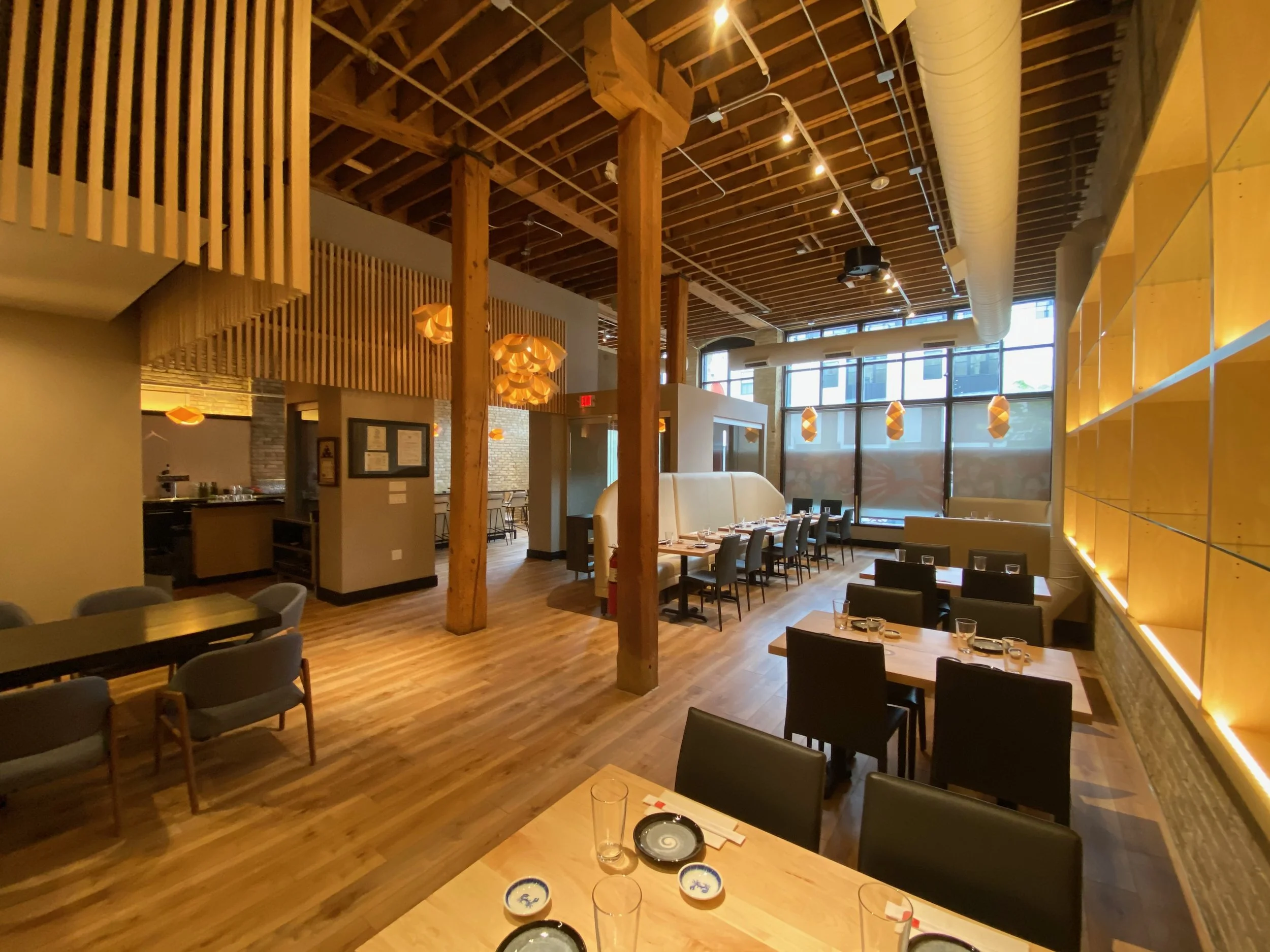 Commercial electrical lighting and fixture installation by Walter Electrical Contractors in Minnesota, featuring pendant lights, recessed lighting, and window-area illumination in a modern restaurant.