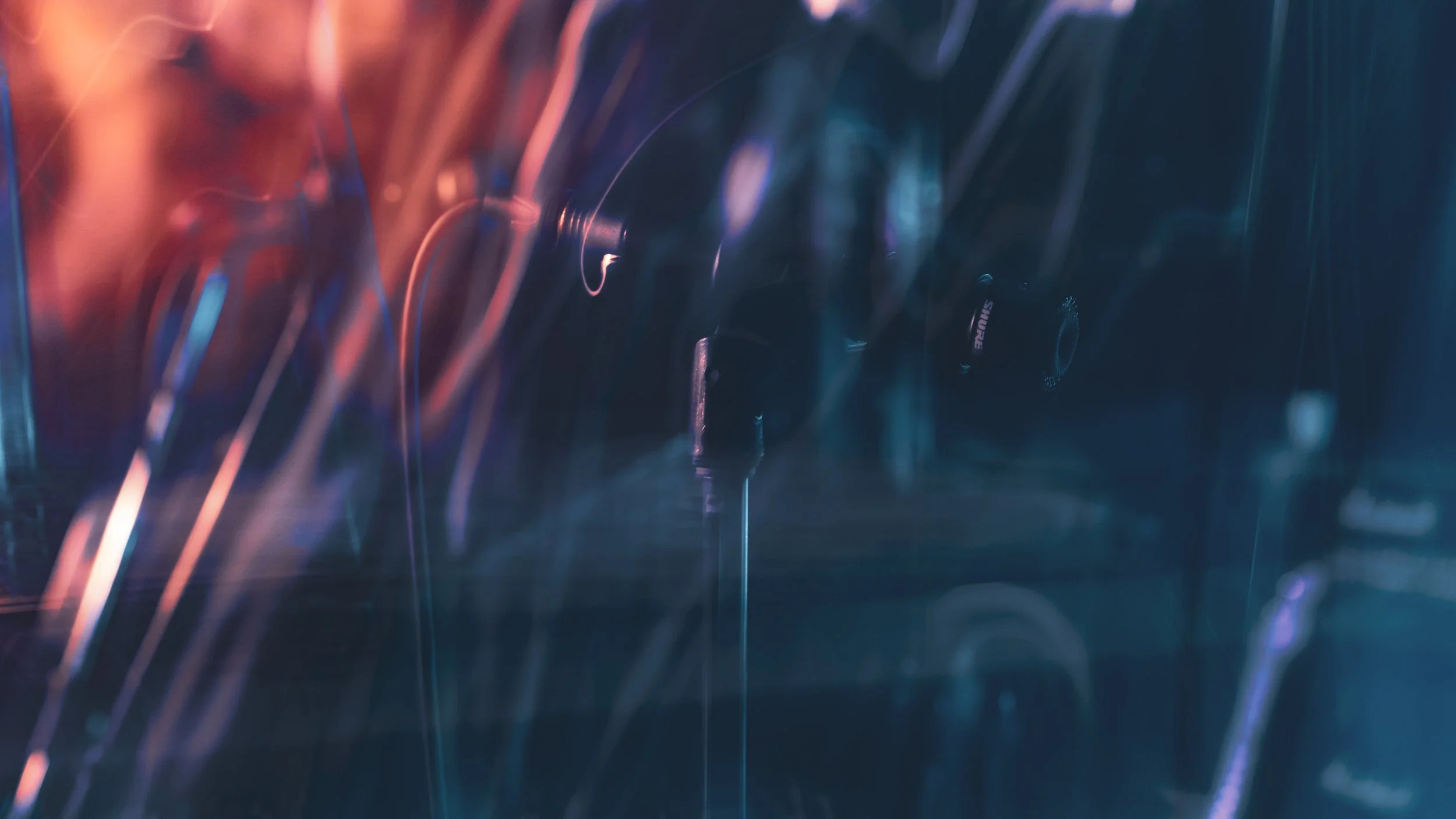 Close-up of turntable needles and vinyl records with colorful lighting effects