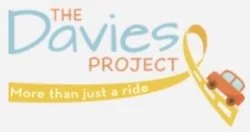 Logo for The Davies Project with a yellow ribbon crossing a road with a car, and the text 'More than just a ride'.