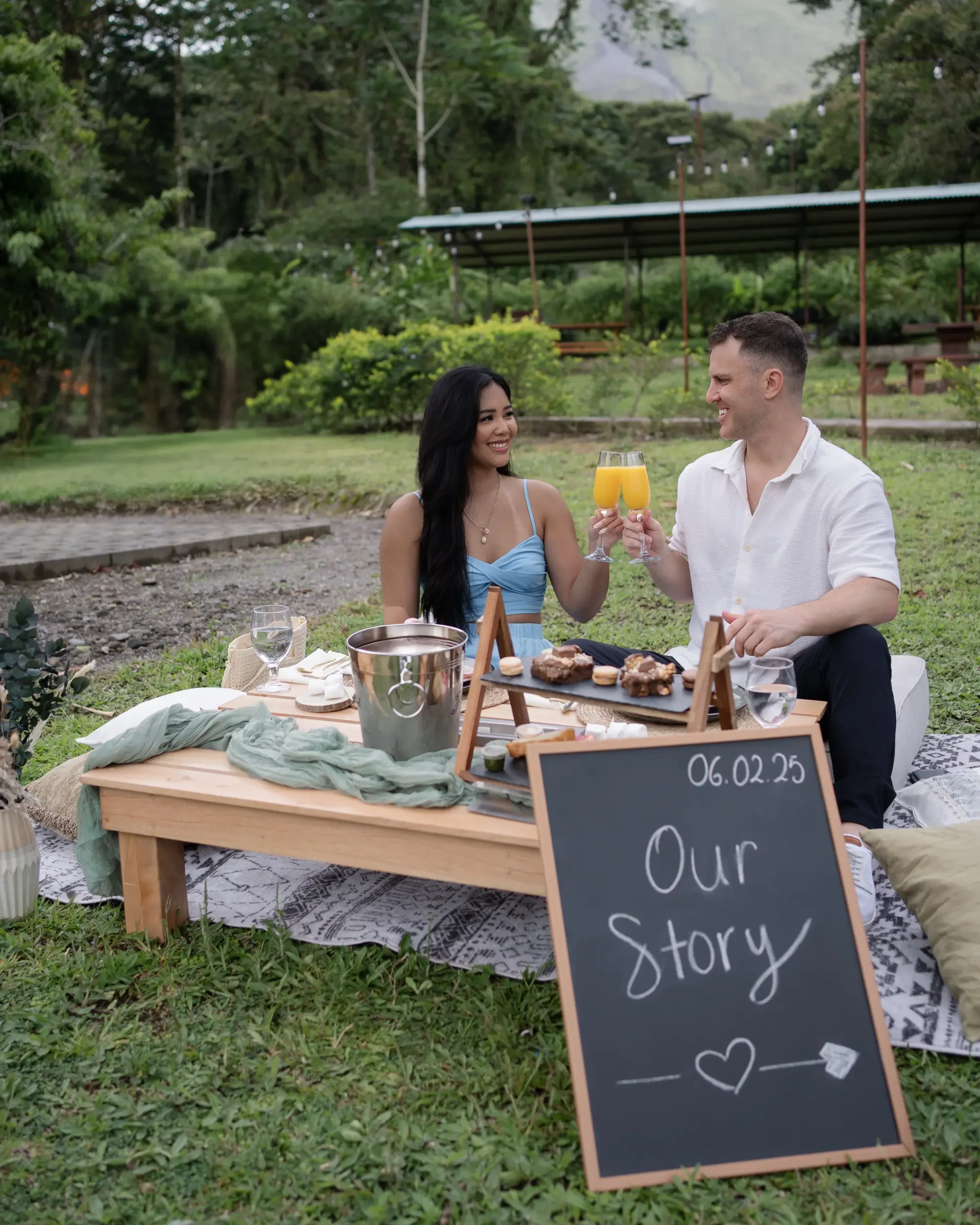 A couple celebrating their engagement with a picnic in a pacific beach in Costa Rinca