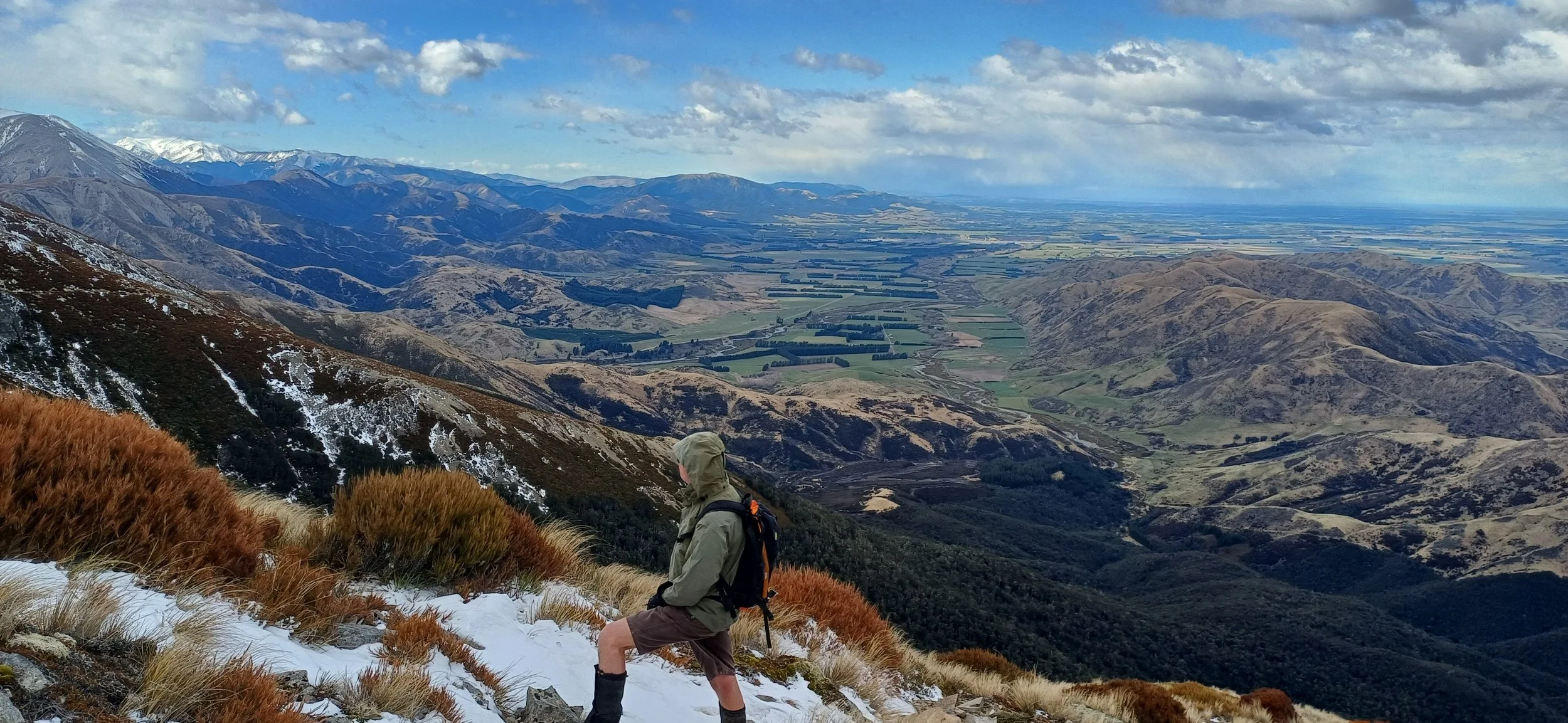 Walker exploring the Torlesse Range foothills just west of Springfield, looking across the Canterbury Plains to Christchurch