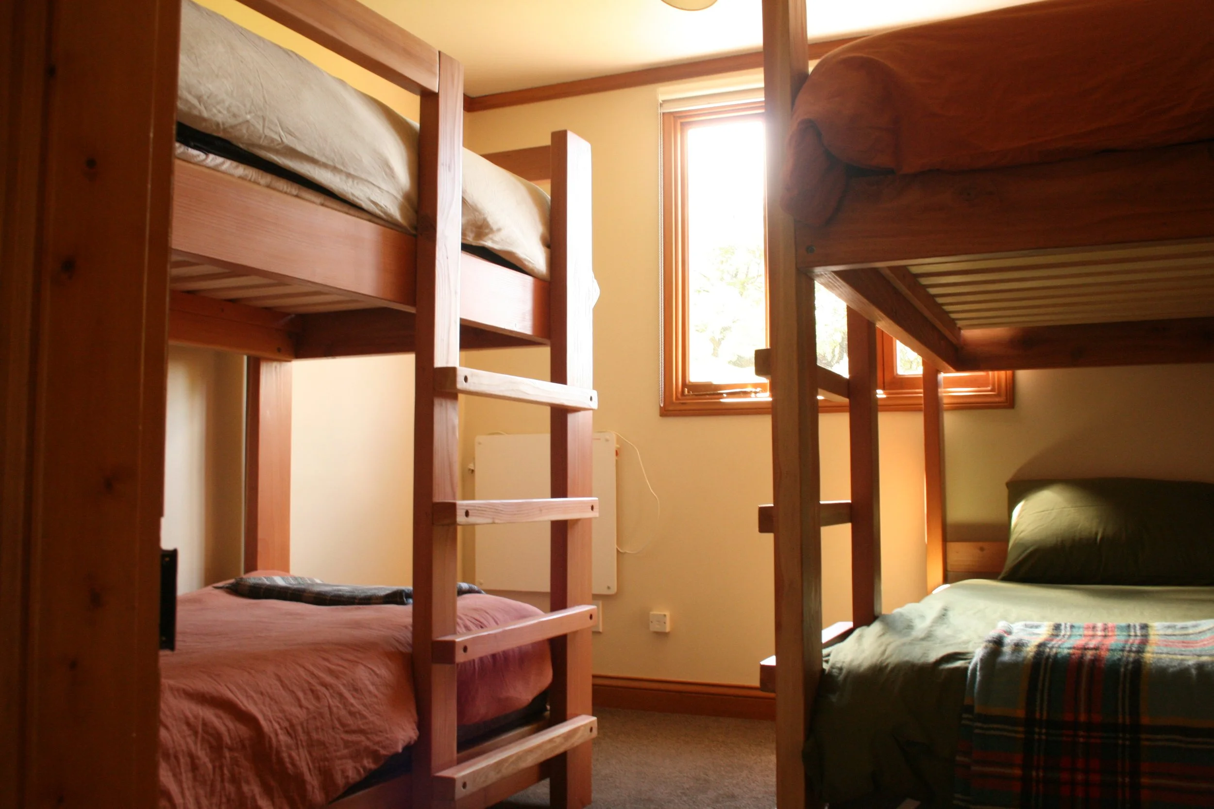 Fantails Rest bunkroom with two bunk beds, with a window allowing natural light facing north